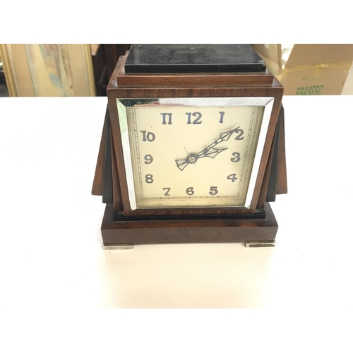 2495 - An Art Deco style mantle clock. 19cm wide by 18cm tall. Seen working. Postage C.