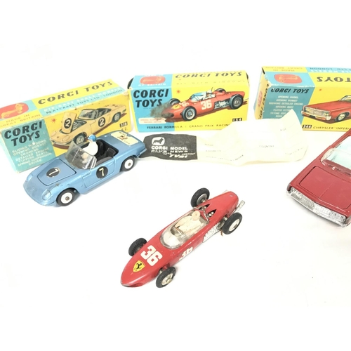 209 - A Boxed Corgi Lotus Elan S2 #318. A Ferrari Formula 1 Car #154 and a Chrysler Imperial #246.