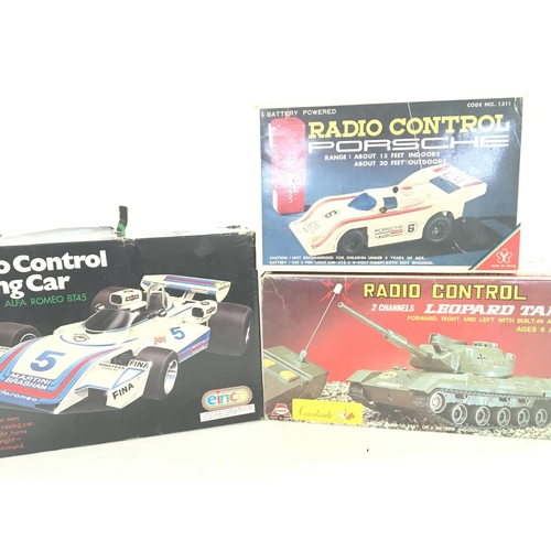 233 - 3 X Boxed Radio Controlled Vehicles including F1 Alfa Romeo. A Leopard Tank and a Porsche.(3).