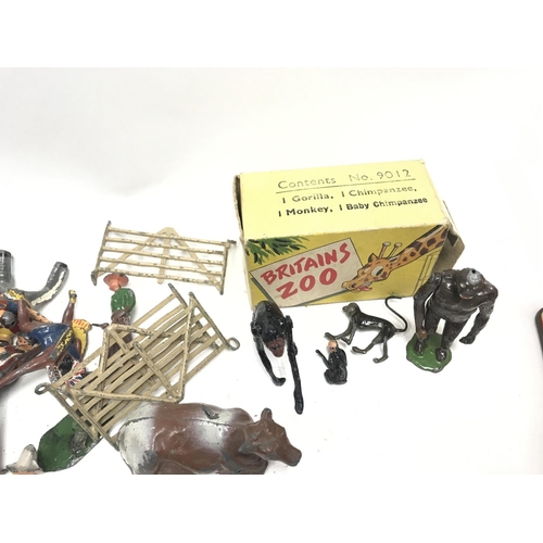 353 - A Tin Containing a Collection of Various playworn Lead Figures including a Boxed Britains Zoo #9012.