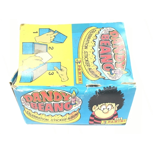 375 - A Panini Trade Box Containing Dandy Beano Celebration Stickers. Still in Packets. Some packets have ... 