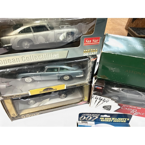 423 - A Box Containing Various Boxed Aston Martins. Including Sun Star. And James Bond.