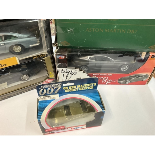 423 - A Box Containing Various Boxed Aston Martins. Including Sun Star. And James Bond.