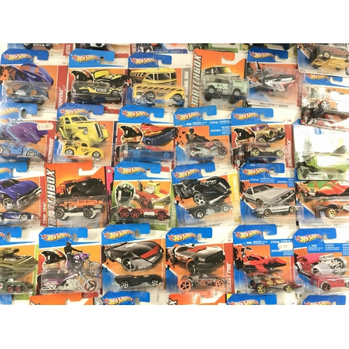 74 - A Box Containing a Large Collection of Carded Hotwheels and Matchbox Vehicles.
