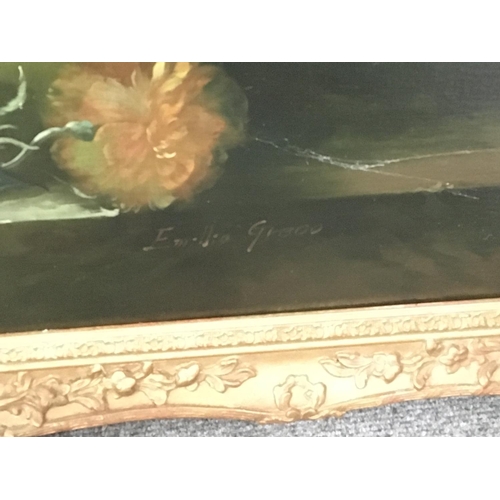 100 - A large gilt framed oil painting on canvas still life study of a profusion of flowers signed by the ... 