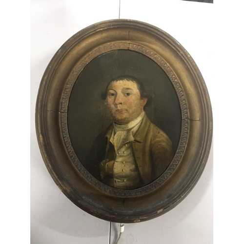 12 - An 18th century oil painting on panel portrait of a young Gentleman in an oval frame The reverse wit... 