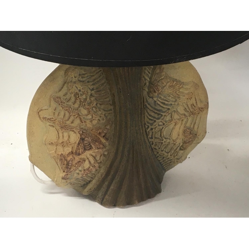 229 - A Ceramic Contemporary lamp with raised insects moths with a black shade Height. 64cm