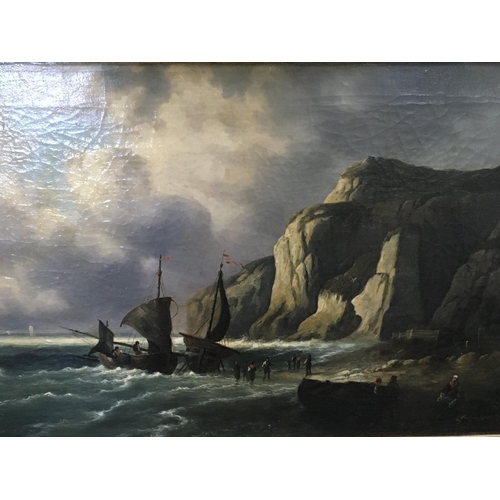 61 - A gilt framed oil painting on canvas Marine oil painting with sailing boats off a beach with figures... 