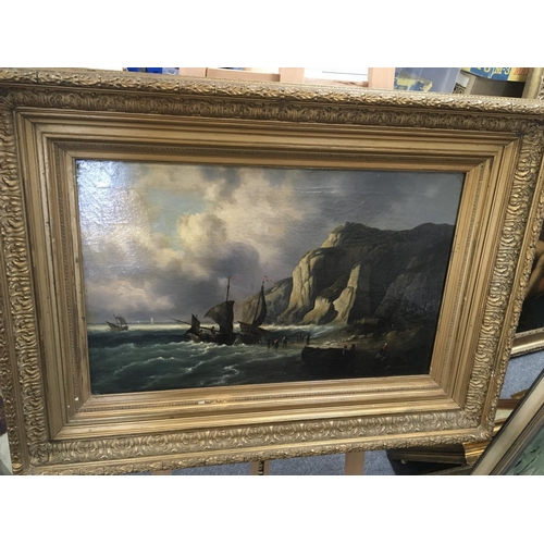 61 - A gilt framed oil painting on canvas Marine oil painting with sailing boats off a beach with figures... 