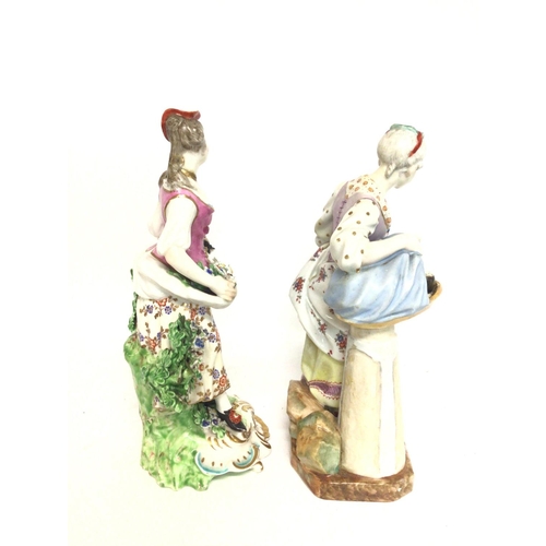 1117 - Porcelain figures of two ladies, unmarked. Approximately 24cm tall. Postage cat D