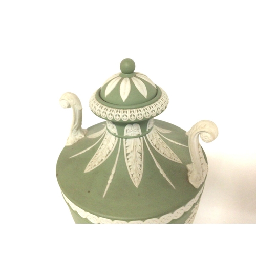 1148 - A Wedgwood neo-classical green Jasper urn, 27cm tall approximately. Postage cat D