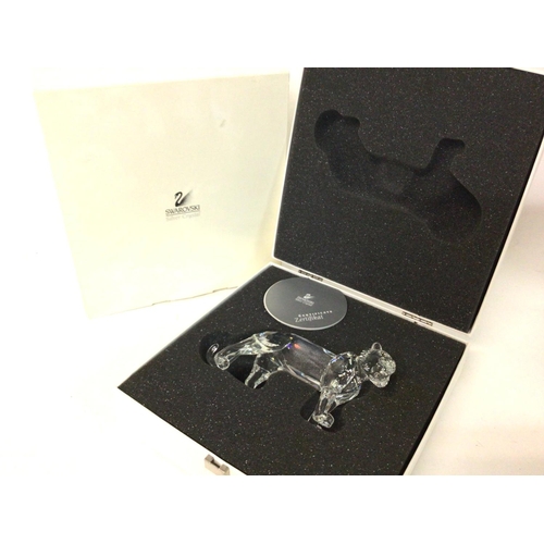 1186 - A boxed Swarovski tiger, no obvious signs of damage /restoration . Postage cat d