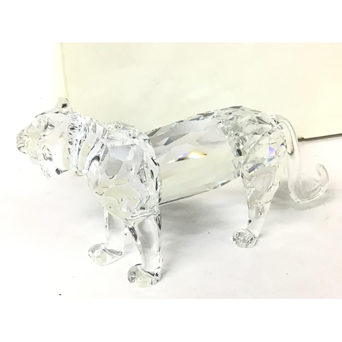 1186 - A boxed Swarovski tiger, no obvious signs of damage /restoration . Postage cat d