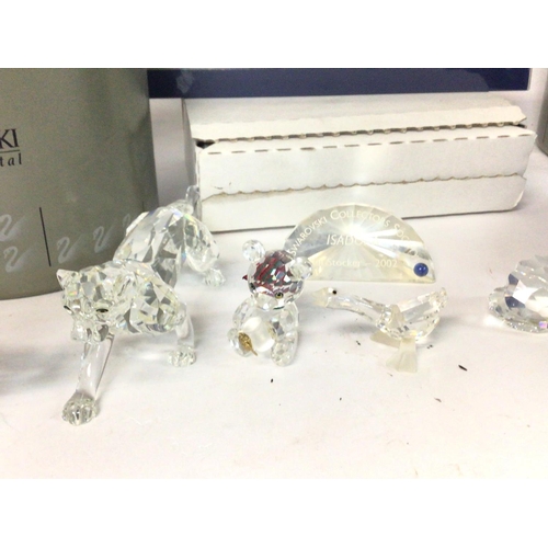 1200 - A collection of boxed Swarovski figurines including a dolphin, tiger, teddy bear, deer, Christmas sl... 