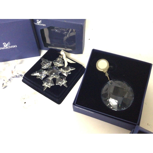 1202 - A collection of small boxed Swarovski figures and ornaments postage cat d