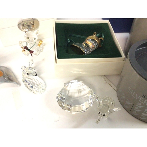 1205 - A collection of boxed small Swarovski figures and ornaments . Cat d postage