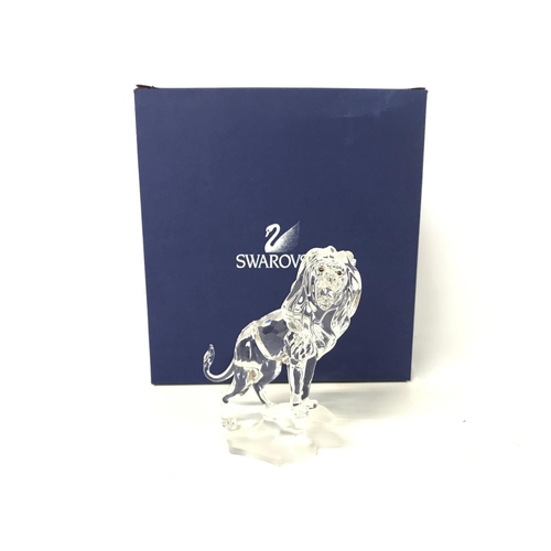 1217 - Boxed Swarovski lion standing on a rock, postage cat D no signs of obvious damage/ restoration