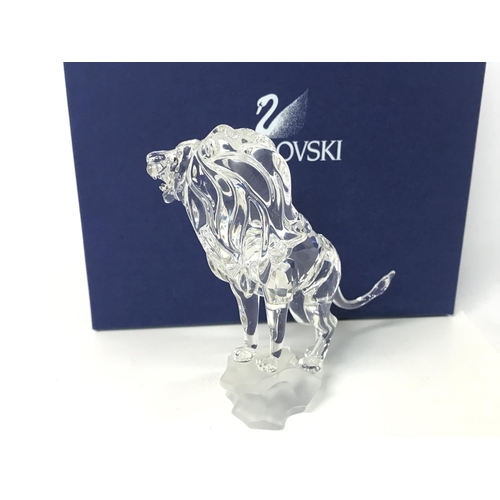 1217 - Boxed Swarovski lion standing on a rock, postage cat D no signs of obvious damage/ restoration