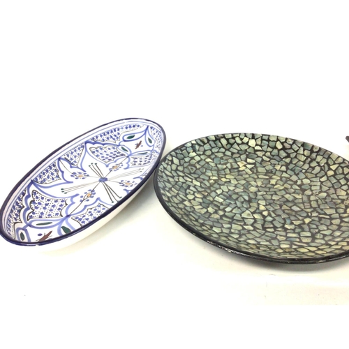 1229 - Two dishes including a mother of pearl rounded dish and a Moroccan art style oval dish . Postage cat... 