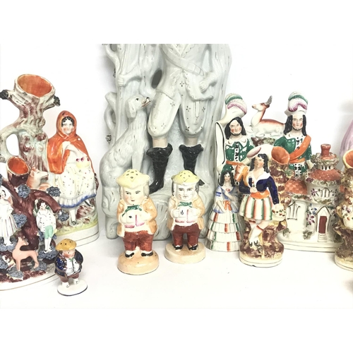 1300 - A large collection of Staffordshire porcelain figures consisting of Little Red Riding hood, Robin Ho... 