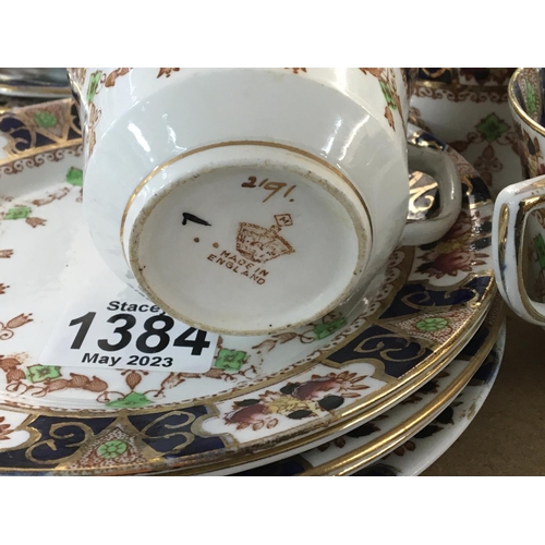 1384 - A British porcelain tea set early 20th century with a gilt and deep blue pattern eight cups saucers ... 