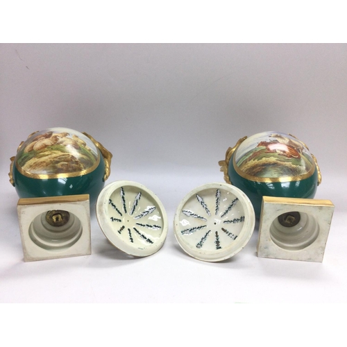 1394 - A pair of unmarked Royal Worcester hand painted urns and covers with panels depicting sheep and catt... 