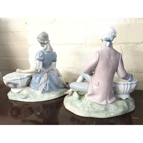 1422 - A pair of Lladro figures of a boy and girl seated with large Jardinere, postage cat D some damage