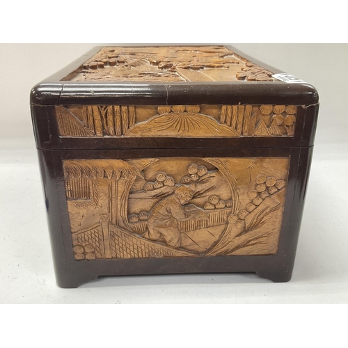 1501 - A small 1920s carved camphor wood lined carved jewellery casket. 30cm x 16cm x 20cm