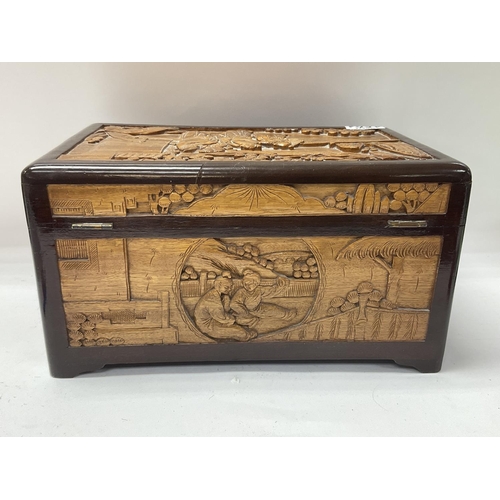 1501 - A small 1920s carved camphor wood lined carved jewellery casket. 30cm x 16cm x 20cm