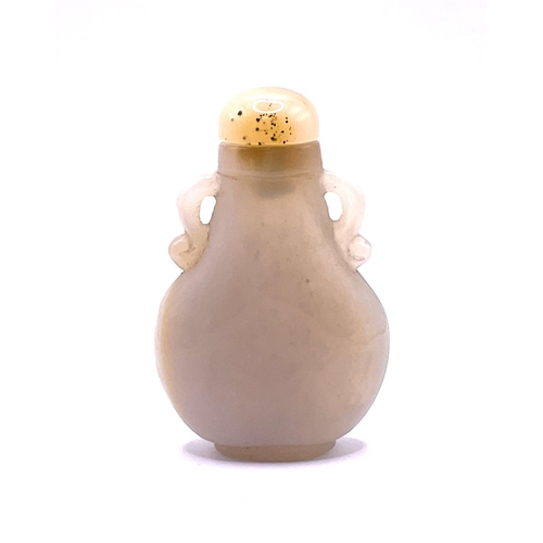 1520 - A carved pear shaped white agate snuff bottle with a similar agate stopper. 7cm.