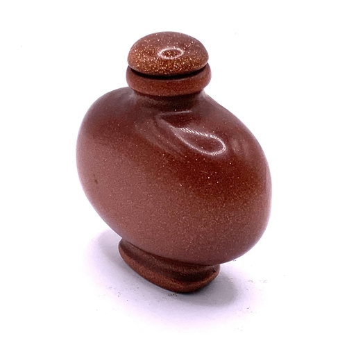 1524 - A modern polished goldstone snuff bottle. 6cm.