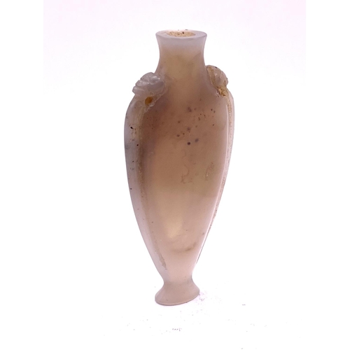 1527 - A finely carved elongated carved pale opalescent agate snuff bottle, with lion head motif to the sho... 