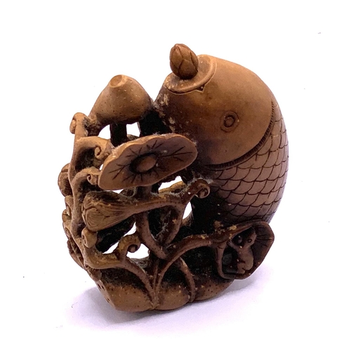 1533 - A Chinese carved fruit wood snuff bottle in the form of a leaping fish. 7.5cm.