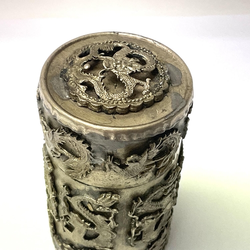 1544 - A Chinese white metal match golden and cover with raised dragon decoration.