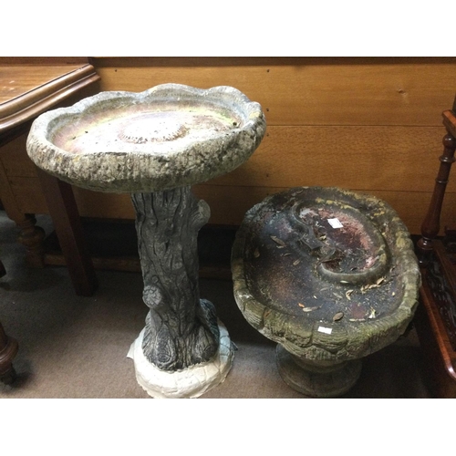 1610 - A modern garden table and two chairs plus some stone garden ornaments. Shipping category D.