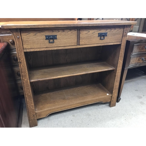 1630 - A oak Arts and crafts style book case with open selfs , together with a matching side cabinet with s... 