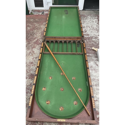 1655 - A mahogany folding bagatelle table, circa 1860, panelled front.