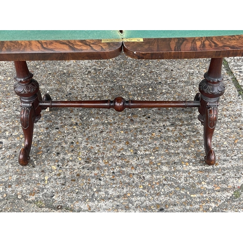 1657 - A Victorian Walnut inlaid folding topped card table with stretcher base. 92 x 45 x 70cm. (D).