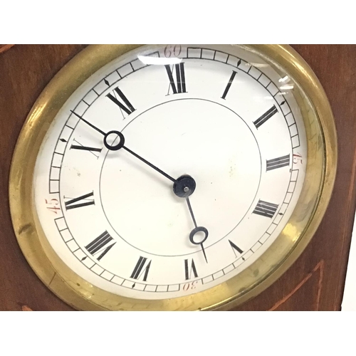 1661 - Small mahogany Edwardian clock in a mahogany inlaid case. In working order, 21cm tall. postage cat D