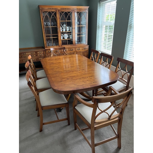 1663 - A Yew wood dining table and matching chairs,