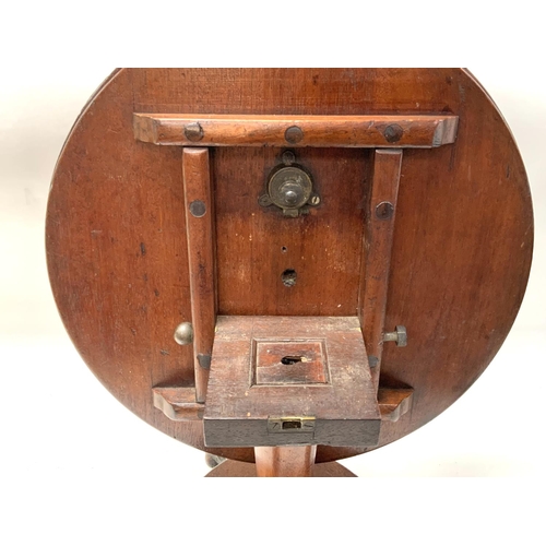 1670 - A small Victorian cabinet makers model of a mahogany circular topped dining table with lions paw fee... 