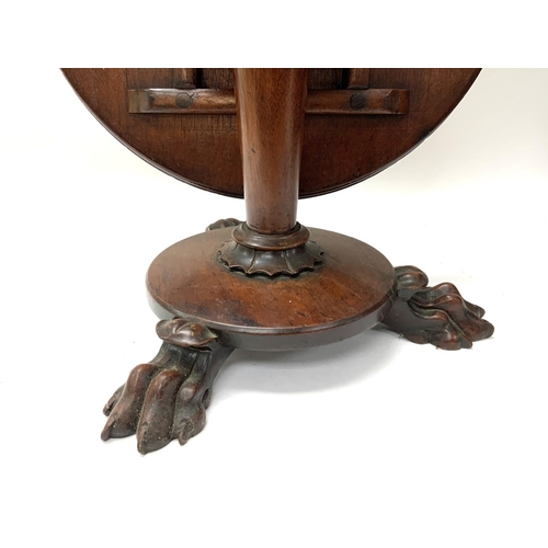 1670 - A small Victorian cabinet makers model of a mahogany circular topped dining table with lions paw fee... 