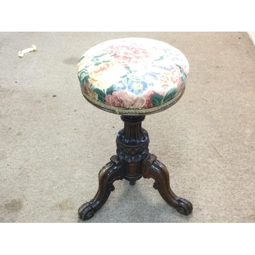 1683 - Revolving and adjustable Victorian walnut music stool with floral seat and a carved tripod base, app... 