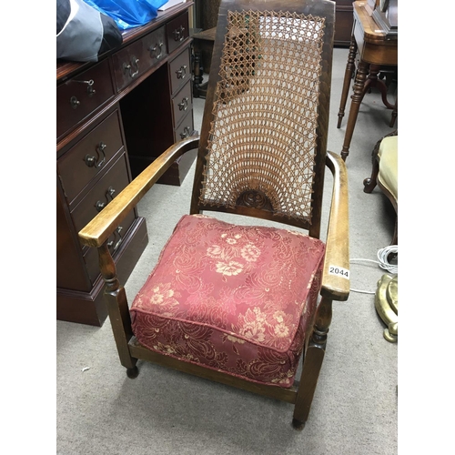 1686 - A beechwood occasional open arm chair with a patterned cane back and drop in cushion. NO RESERVE