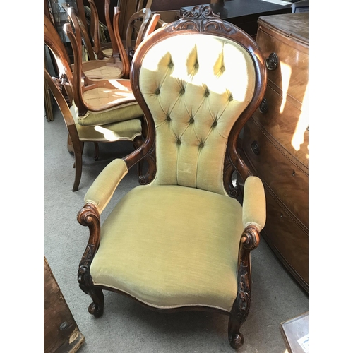 1694 - A Victorian mahogany open arm chair upholstered in green, 56x60x100cm approximately.