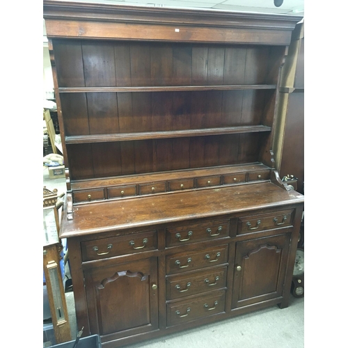 1700 - A Quality oak dresser with a raised back above seven small drawers the base with further drawers and... 