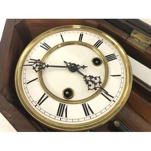 1720 - Wall Clock with key and pendulum ,in a oak case with ebonised embellishments. Approximately 90cm lon... 