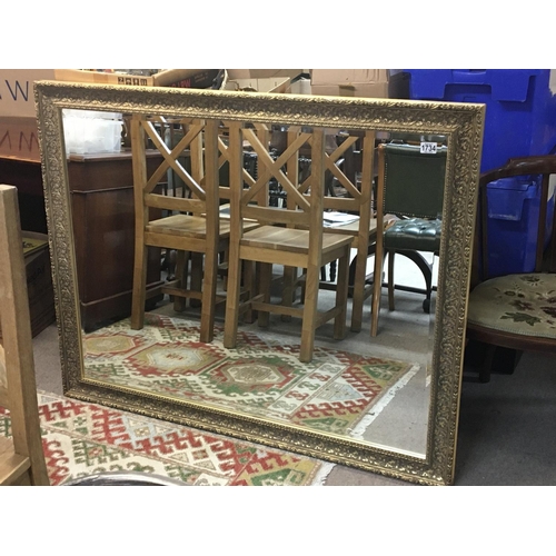 1734 - A large gilt framed wall mirror of rectangular shape 130x102cm