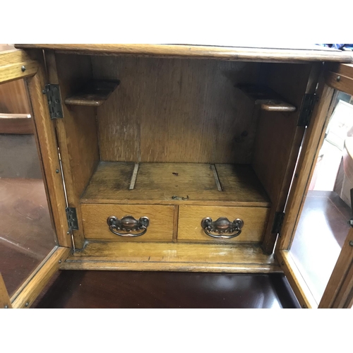 1744 - Oak smokers cabinet with a tin of cigars, Shipping category C.