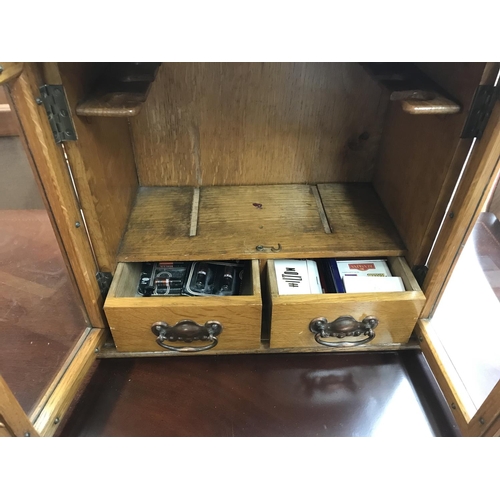 1744 - Oak smokers cabinet with a tin of cigars, Shipping category C.